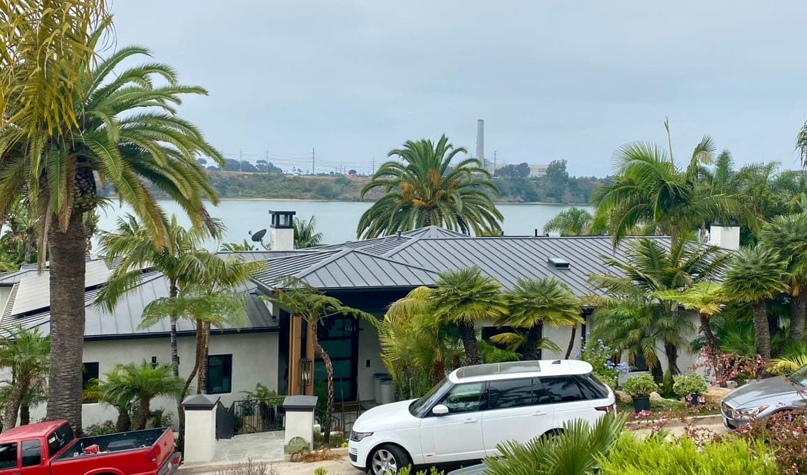 Upscale La Jolla bluff home with a copper standing-seam metal roof above the Pacific Ocean