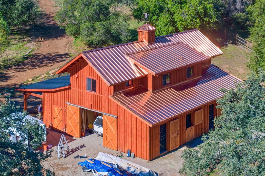 Escondido inland home with a metal roof against hills and evening light