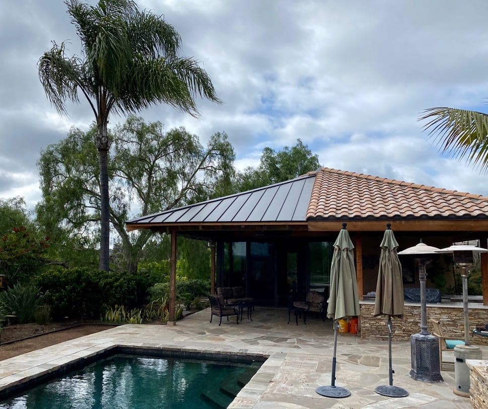 Upscale Del Mar coastal home with a standing seam metal roof near the Pacific Ocean
