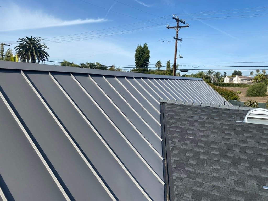 Solana Beach coastal home with a dark standing seam metal roof near the ocean bluffs